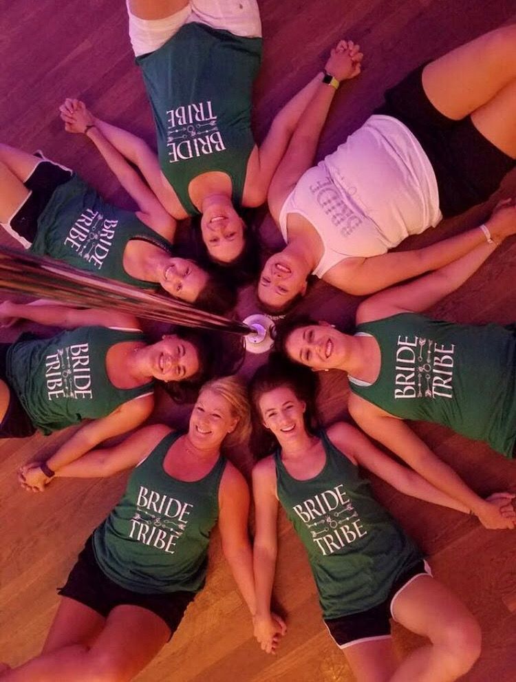 Bride tribe group lying in a circle in matching green tanks