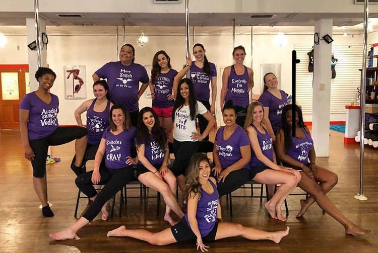 Students in matching purple shirts posing in the studio